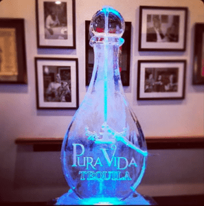 Bottle shaped Ice Luge with the logo for Pra Vida Tequila etched on the side; by Full Spectrum Ice Sculptures; Serving Austin to San Antonio