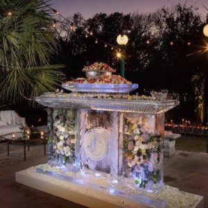 Large Seafood Bar made of ice encasing a floral display by Full Spectrum Ice Sculptures