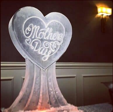 Mother's Day ice sculpture in the shape of a heart on a pedestal by Full Spectrum Ice Sculptures