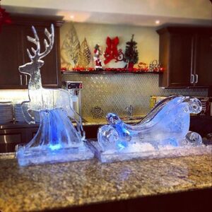 Ice Sculpture in the shape of a reindeer with a sleigh for holiday display by Full Spectrum Ice Sculptures
