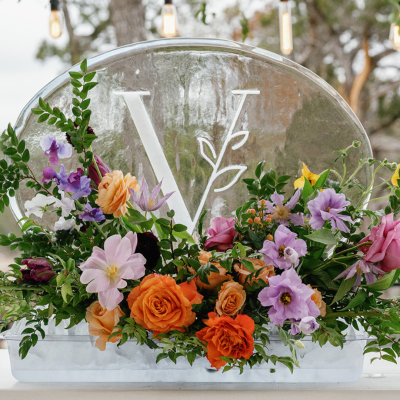 Wedding Ice Sculpture Display of a snow filled V with leaves as part of the design and beautiful flowers
