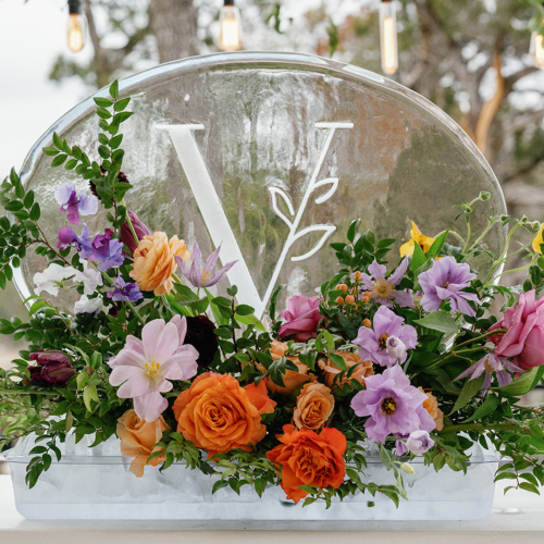 Wedding Ice Sculpture Display of a snow filled V with leaves as part of the design and beautiful flowers