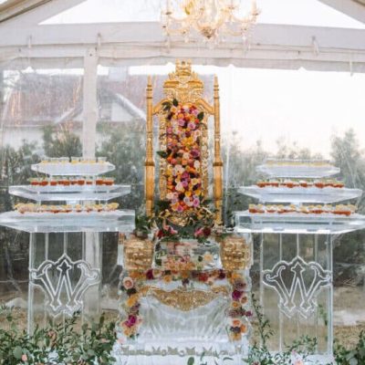 golden throne on ice with floral arrangement frozen in ice by Full Spectrum Ice Sculptures for wedding with the Whitt Experience, Austin, Texas