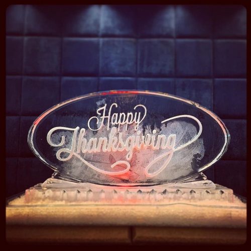 Oval ice sculpture etched with Happy Thanksgiving on the front